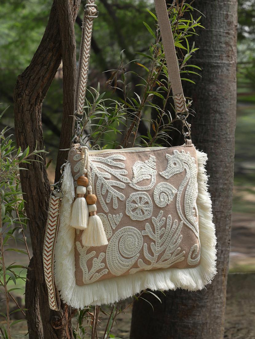 beige embroidered sling bag