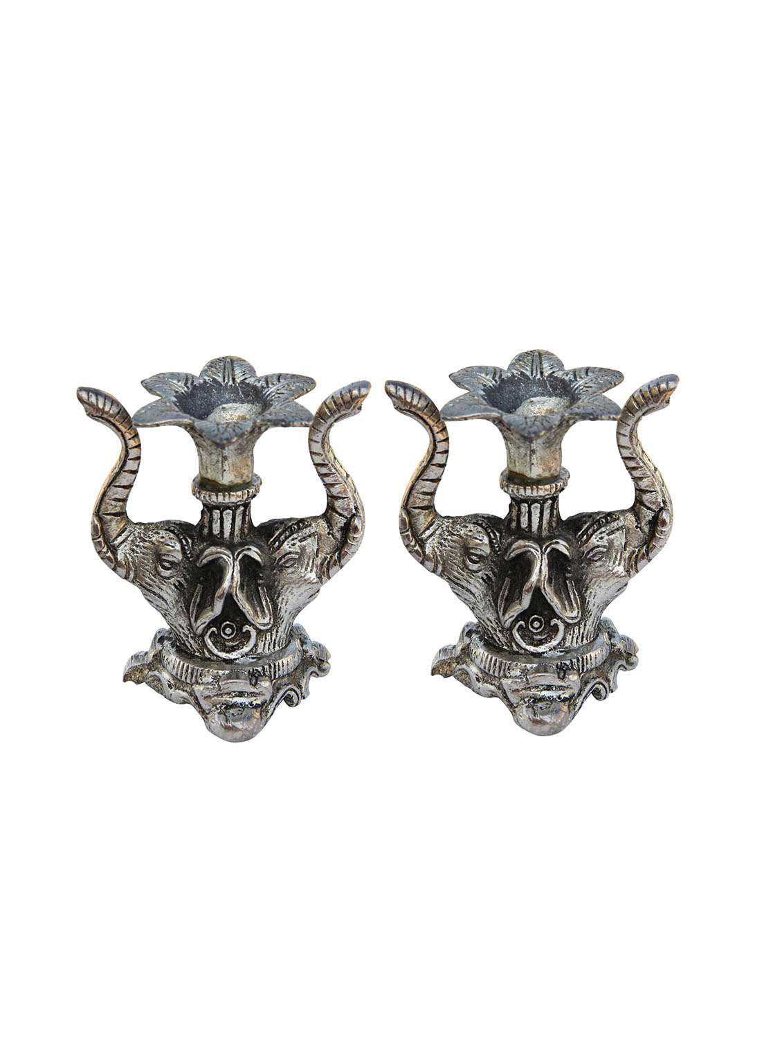 pair of candle holders placed on double elephants head in metal