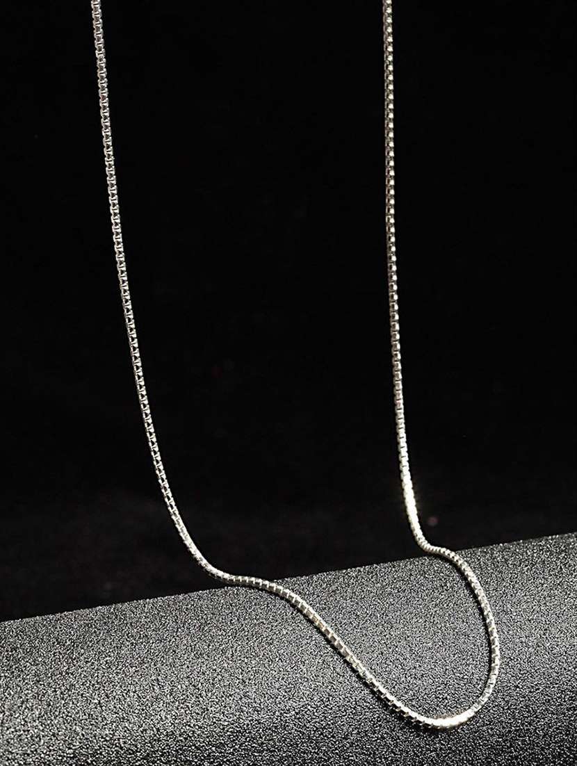 silver colored metal pendant