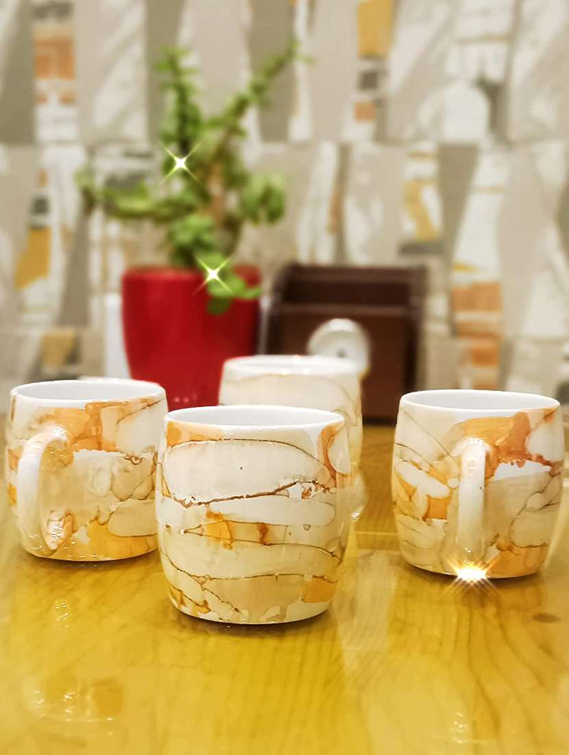 caffeine ceramic handmade yellow tea cup set (set of 4) - 19408789 -  Standard Image - 1