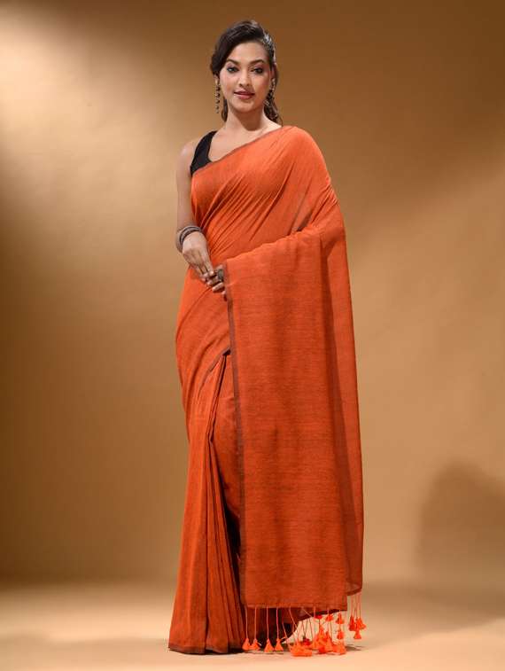 women's solid orange colored saree with blouse