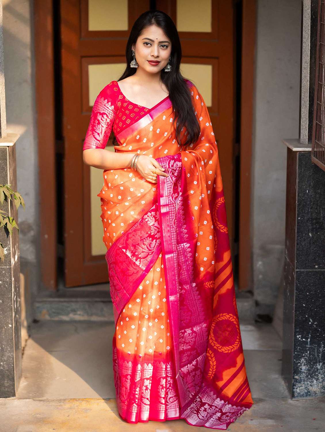 women orange bandhani printed saree