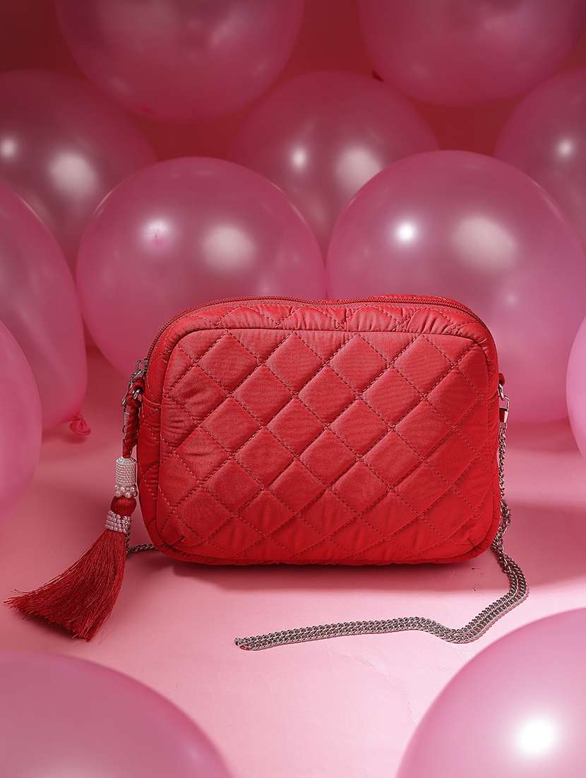 women red solid quilted sling bag