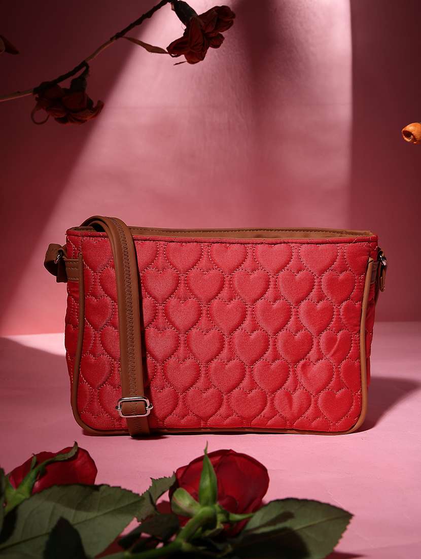 women red solid quilted sling bag