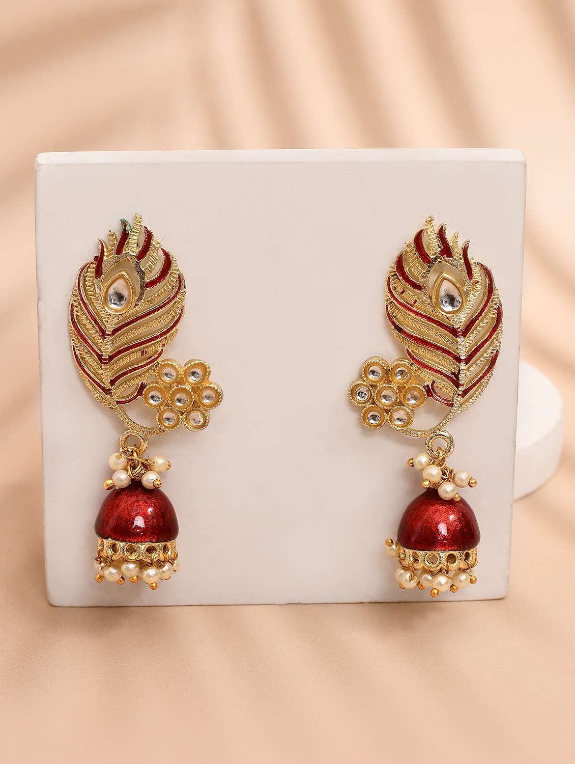 maroon & gold-plated kundan stone leaf shaped jhumka earrings