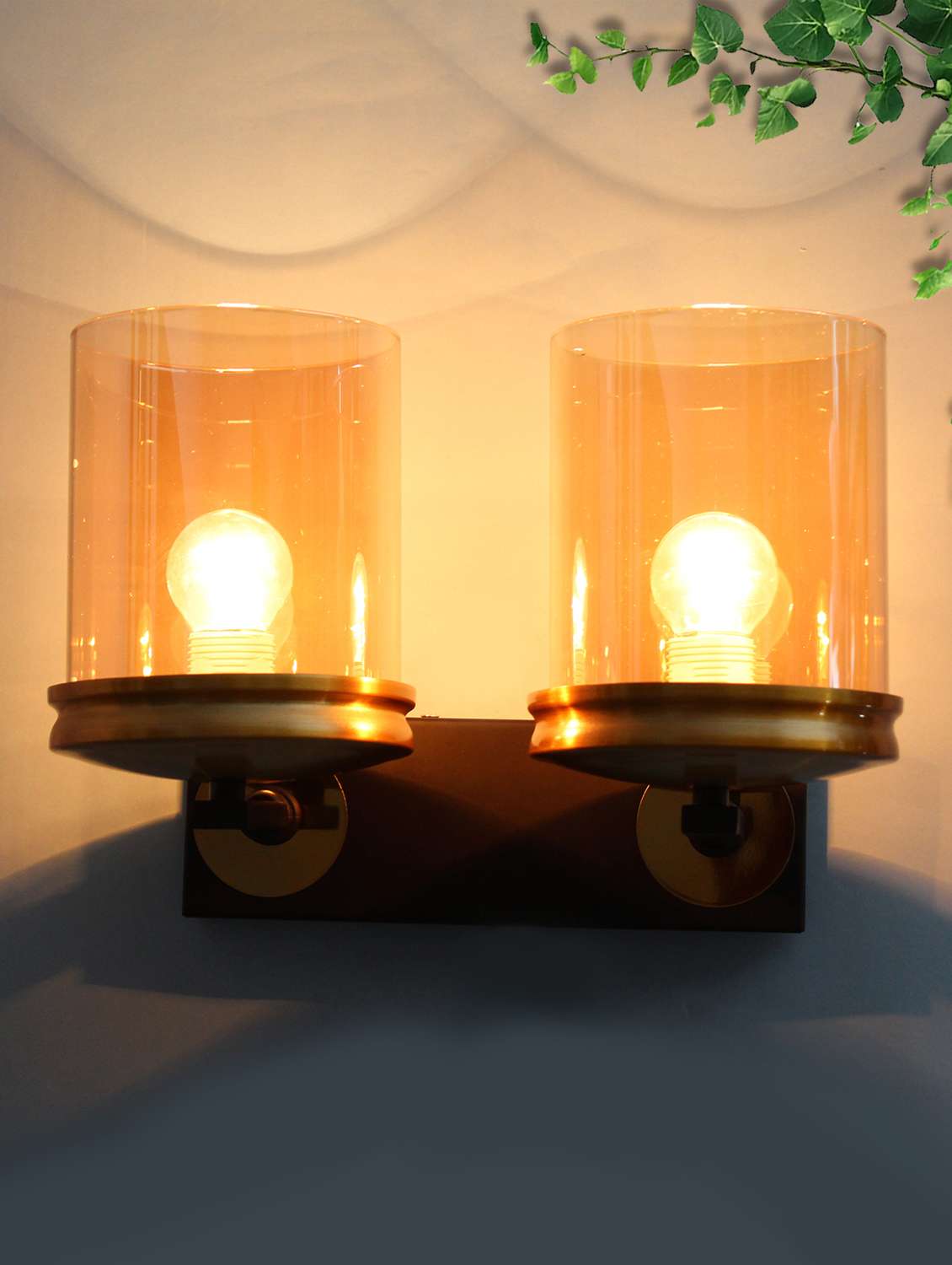 modern double arm wall sconce with amber glass