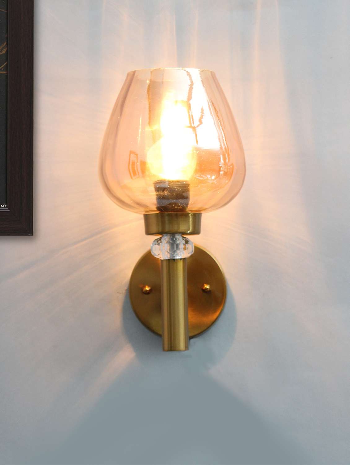 enhance your space with golden wall light with luster glass