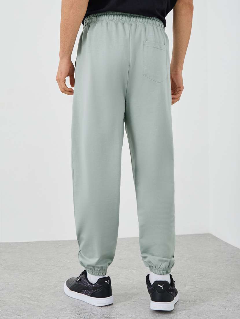 men typographic mid rise loose fit jogger - 21971631 -  Standard Image - 1