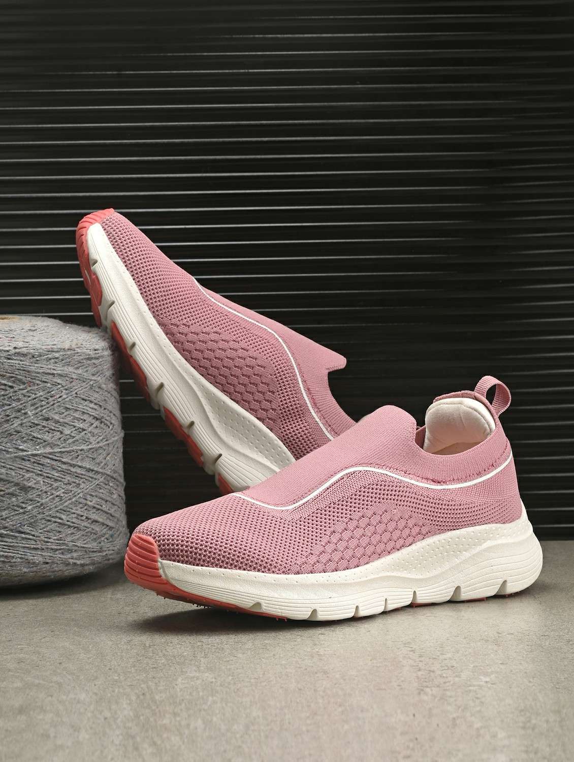 women pink slip on sports shoe