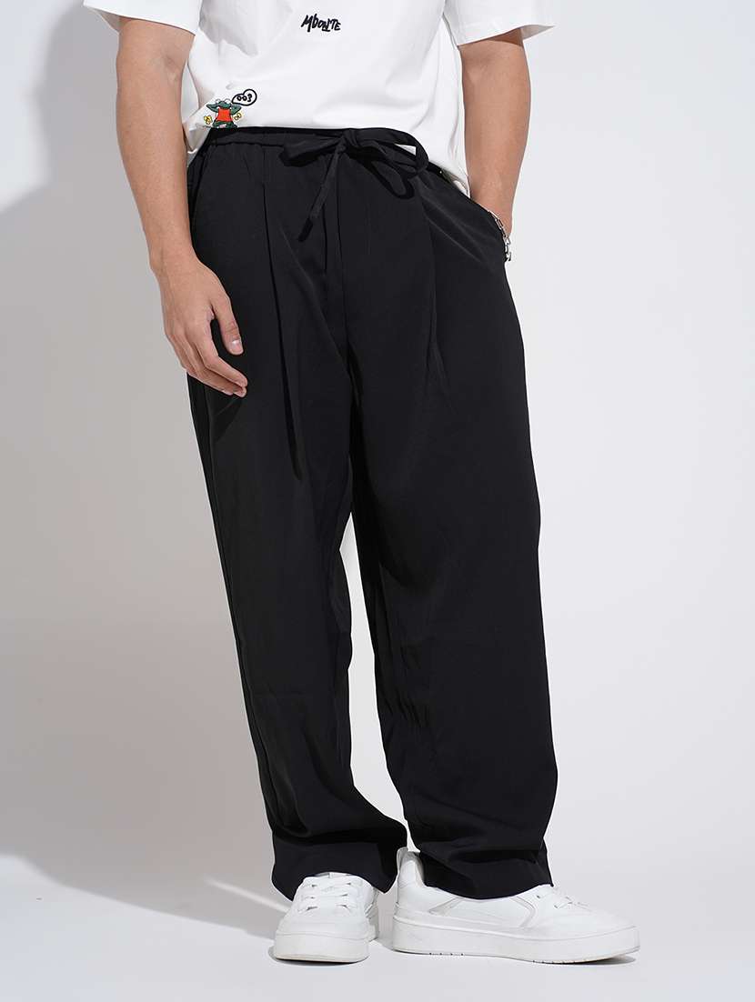 men black solid low rise loose fit parachute pant