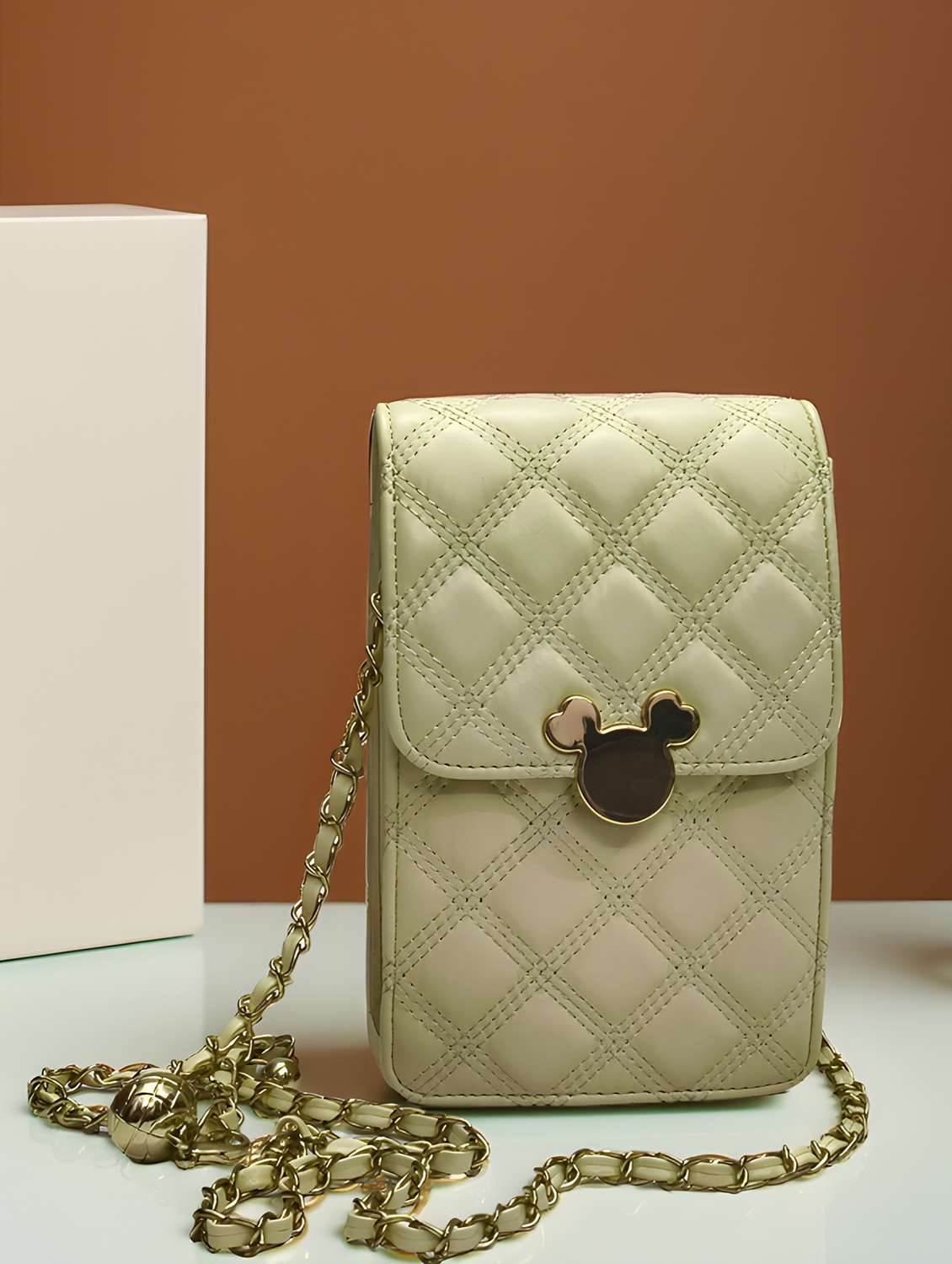 women textured sling bag with chain strap