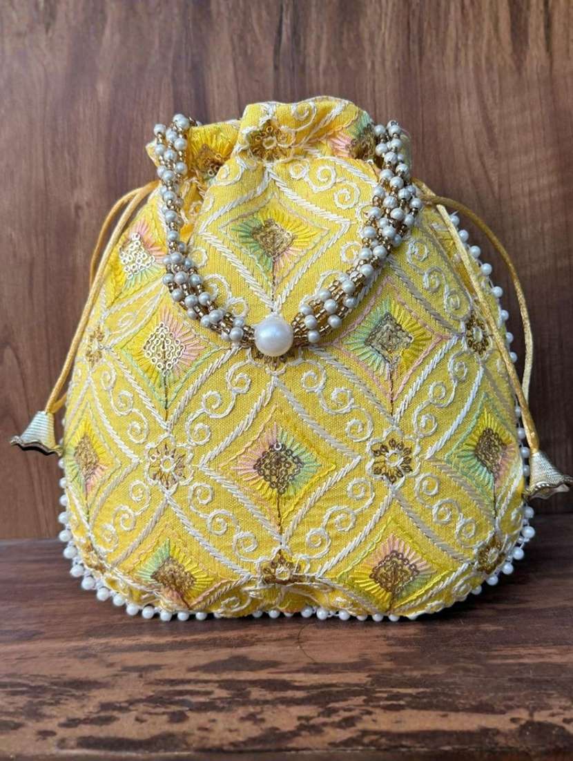 women solid with work embroidered potli