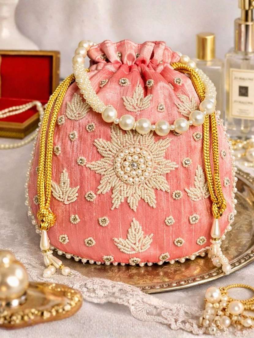 women solid with work embellished potli