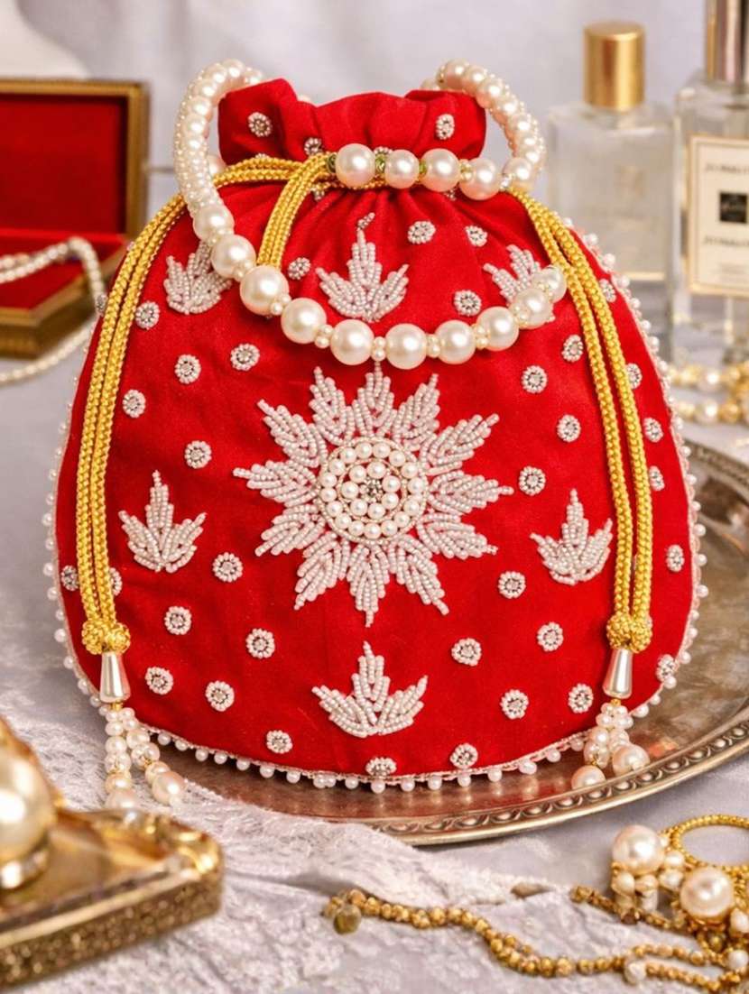 women solid with work embellished potli