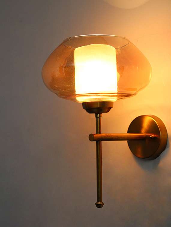 elegant brass wall sconce with amber kachori glass