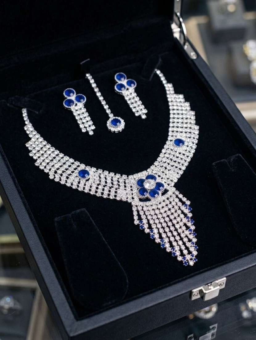 women blue brass stone work necklace earring and maang tikka set